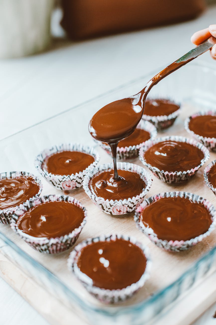pouring chocolate batter into cupcake moulds
