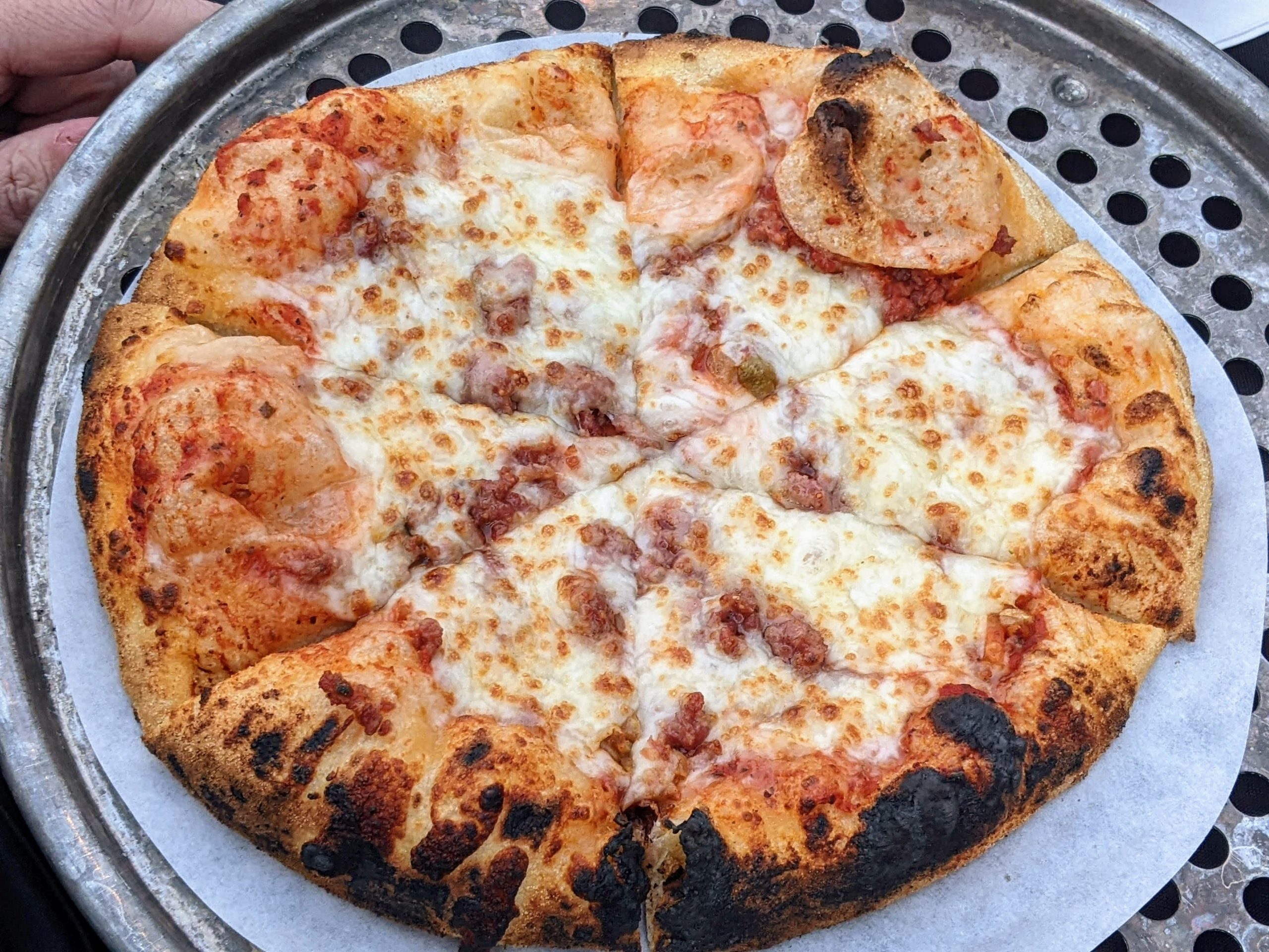 Meat pizza by Crafted Food Services at the Plant Life Pizza Picnic outside of Des Moines