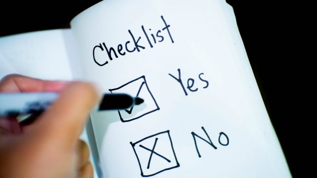 poll, person marking check on opened book