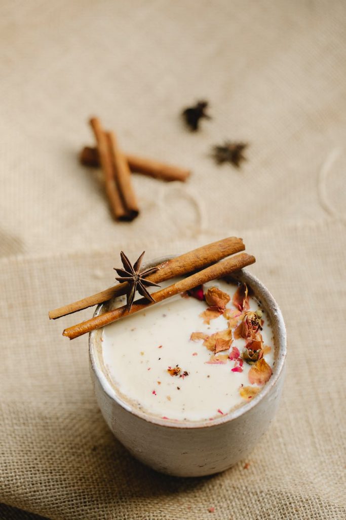 ceramic cup of chai tea with cinnamon and star anise on linen fabric